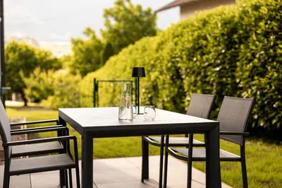 a black table and chairs on a patio at Villa Sawian in Appiano sulla Strada del Vino