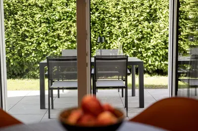 a table and chairs and a bowl of fruit on a table at Villa Sawian in Appiano sulla Strada del Vino