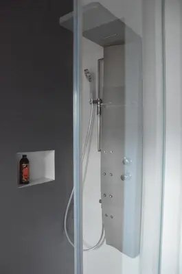 a shower with a glass door in a bathroom at Mountain Suite with tub and view, Alpine design in Sanzeno