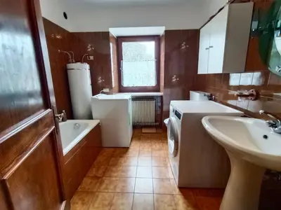 a bathroom with a sink and a toilet and a tub and a sink at Stella Alpina in Romeno