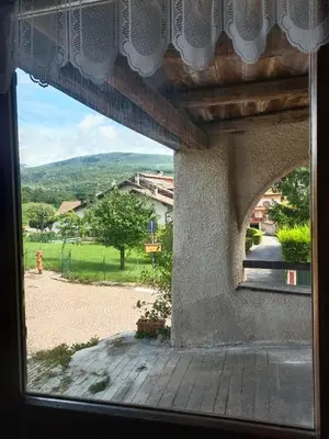 a window with a view of a courtyard at Stella Alpina in Romeno