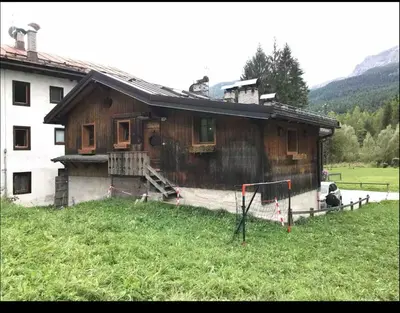 a wooden house with a goal in front of it at Cottage Cortina d Ampezzo in Cortina dʼAmpezzo