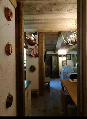 a room with a dining table and a bedroom at Cottage Cortina d Ampezzo in Cortina dʼAmpezzo