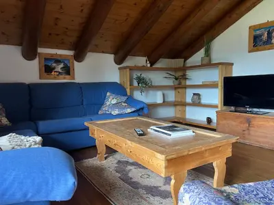 a living room with a couch and a table at Chalet vista montagne in San Vito di Cadore