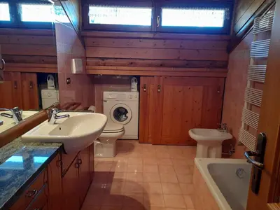 a bathroom with a tub and a sink at Chalet vista montagne in San Vito di Cadore