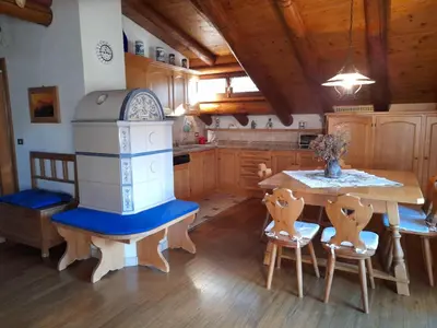 a kitchen with a table and a stove at Chalet vista montagne in San Vito di Cadore