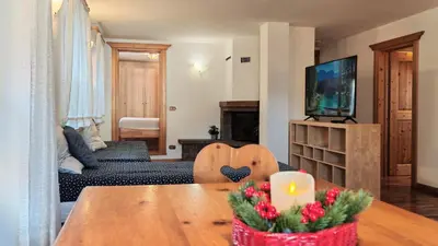 a living room with a table with a candle on it at Tabia del Caser in San Tomaso