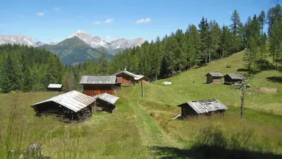 a group of huts on a hill in a field at Tabia del Caser in San Tomaso