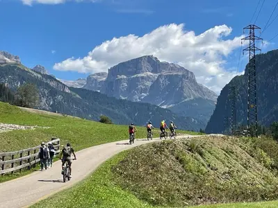 a group of people riding bikes down a road at Il Sole delle Dolomiti in Campestrin
