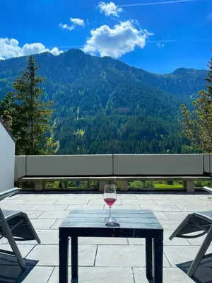 a living room with a table and a dining room at Il Sole delle Dolomiti in Campestrin