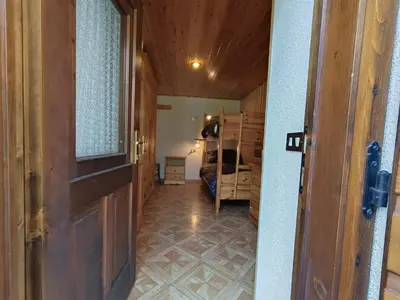 a door leading into a room with a bedroom at Coldemies apartment in Alleghe
