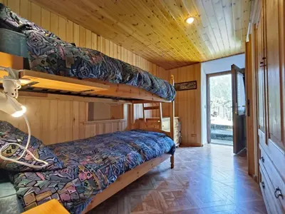 a bedroom with two bunk beds in a cabin at Coldemies apartment in Alleghe