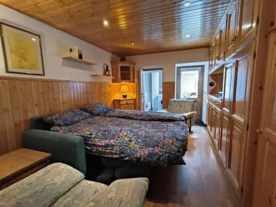 a bedroom with two beds and a couch in a room at Coldemies apartment in Alleghe
