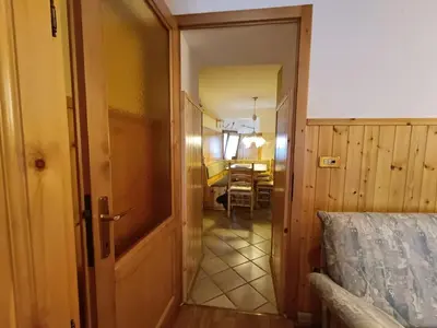 an open door to a room with a bedroom at Coldemies apartment in Alleghe