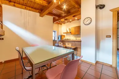 a kitchen and dining room with a table and chairs at Altèra Home in Rocca Pietore