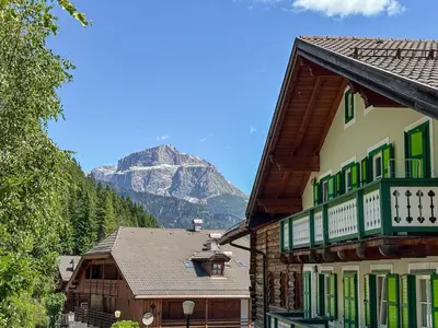 a group of buildings with a mountain in the background at Appartamento Anna in Campestrin