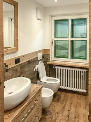 a bathroom with a white sink and a toilet at Appartamento Anna in Campestrin