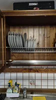 a wooden cabinet with plates and dishes on it at Casa Cecilia Dolomiti - scenic views, pets welcome in Piaia