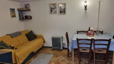 a living room with a couch and a table at Casa Cecilia Dolomiti - scenic views, pets welcome in Piaia