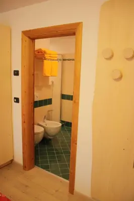 a bathroom with a toilet and a sink at Agriturismo Pianrestel in Cavalese