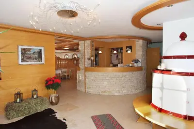 a living room with a lobby with a fireplace at Agriturismo Pianrestel in Cavalese