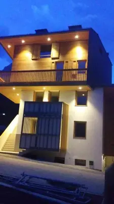 a white house with a balcony on the side of it at Sella Ronda dalla Val di Fassa - CiasaNu 1° Piano in Pozza di Fassa