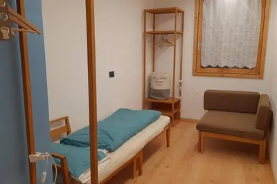 a small room with a bed and a chair at Sella Ronda dalla Val di Fassa - CiasaNu 1° Piano in Pozza di Fassa