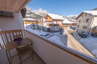 a balcony with a view of a snow covered mountain at Sella Ronda dalla Val di Fassa - CiasaNu 1° Piano in Pozza di Fassa
