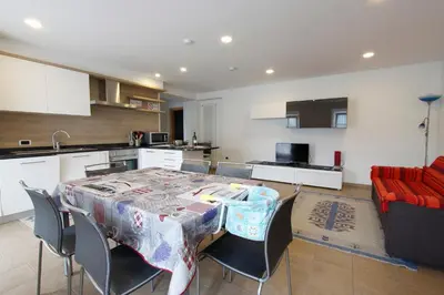 a kitchen and dining room with a table and chairs at Appartamento Diana in Cavalese