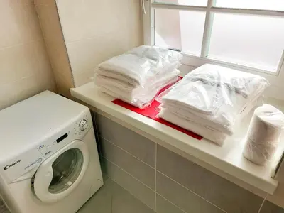 a laundry room with a washing machine and a window at Appartamento Diana in Cavalese