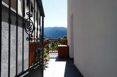 a balcony of a building with a view of the mountains at Appartamento Diana in Cavalese