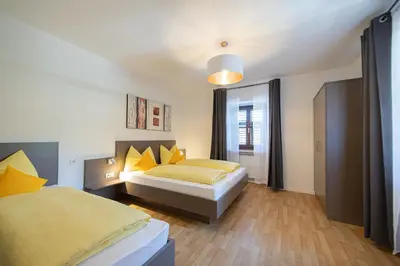 a bedroom with two beds and a window at Ferienwohnung Zum Bachanger in Termeno