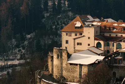 an old castle with snow on top of it at Castel Badia - The Leading Hotels of the World in San Lorenzo di Sebato