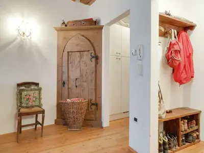 a room with a door and a chair and a table at Modern Apartment, Bressanone in Bressanone