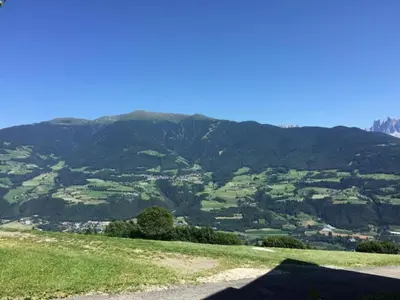a shadow of a person on a hill with a mountain at Modern Apartment, Bressanone in Bressanone