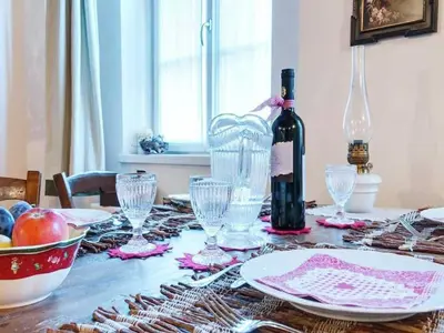 a table with a bottle of wine and glasses on it at Modern Apartment, Bressanone in Bressanone
