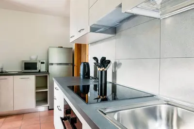 a dining room with a wooden table and chairs at Ciasa Silvano 1721 SV in Falcade