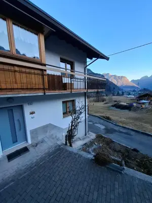 a house with a balcony with a view at Appartamento Sot le Pale in Taibon