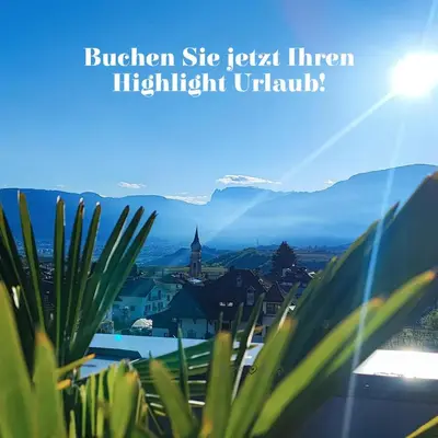 a view of a city with mountains in the background at Highlight Apartments in Appiano sulla Strada del Vino