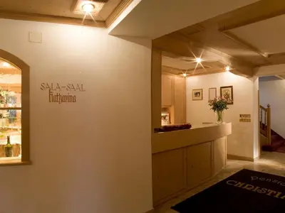 a room with a kitchen with a counter top at Hotel Christian in Corvara in Badia