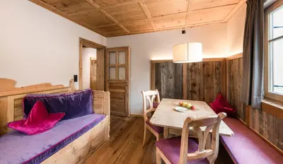 a hotel room with two beds and a tv at Mirabell Dolomites Hotel in Valdaora