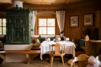 a white plate of food on a table at Mirabell Dolomites Hotel in Valdaora