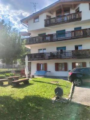 a building with a car parked in front of it at Villa Cecilia mono in Tonadico