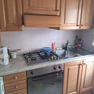a kitchen with a stove and a sink at Villa Cecilia mono in Tonadico