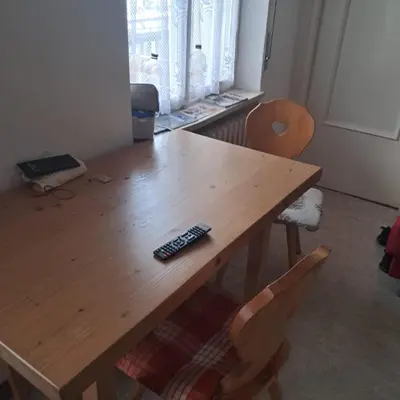 a wooden table with a remote control on top of it at Villa Cecilia mono in Tonadico