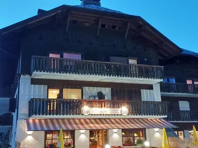 a building with a balcony on the side of it at Carezza Lake Apartment in Carezza al Lago