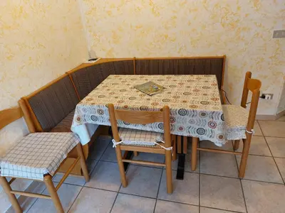 a table with two chairs and a table and a table and chairs at Carezza Lake Apartment in Carezza al Lago