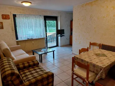 a living room with a couch and a table at Carezza Lake Apartment in Carezza al Lago
