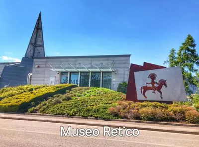 a museum with a statue of a horse in front of a building at Agritur Gioia in Sanzeno