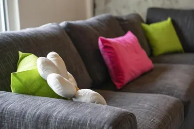 a couch with colorful pillows on it at Agritur Gioia in Sanzeno